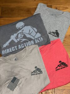 Four t-shirts with 'Direct Action' graphic designs in various colors.