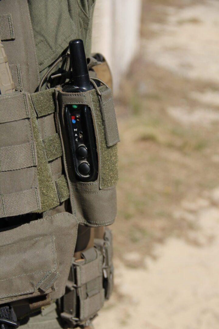 Tactical vest with attached radio device